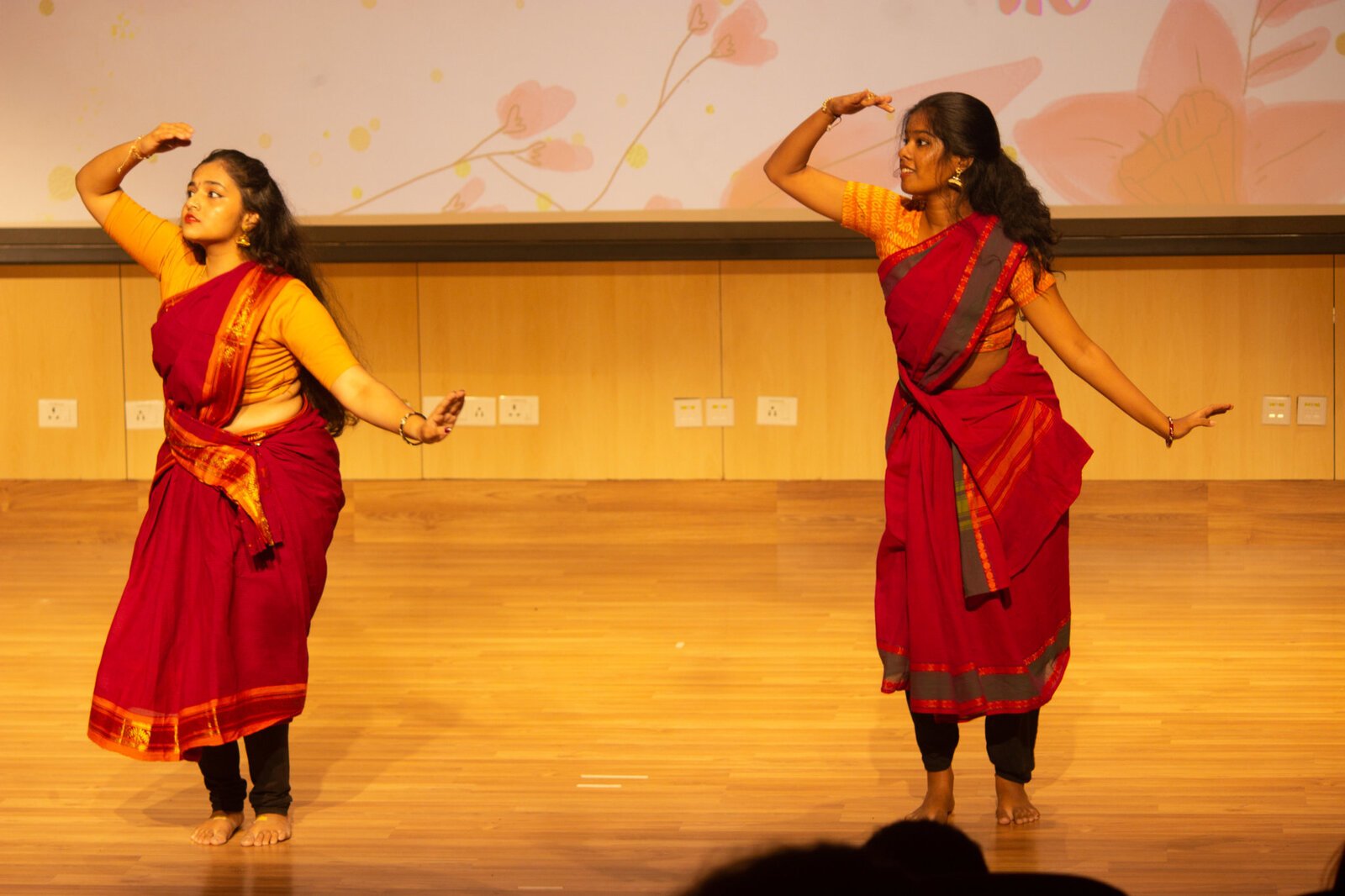 2 students doing dance in r4ed saree