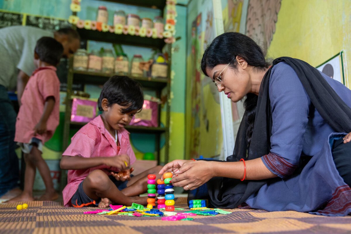 ECCE teacher with student