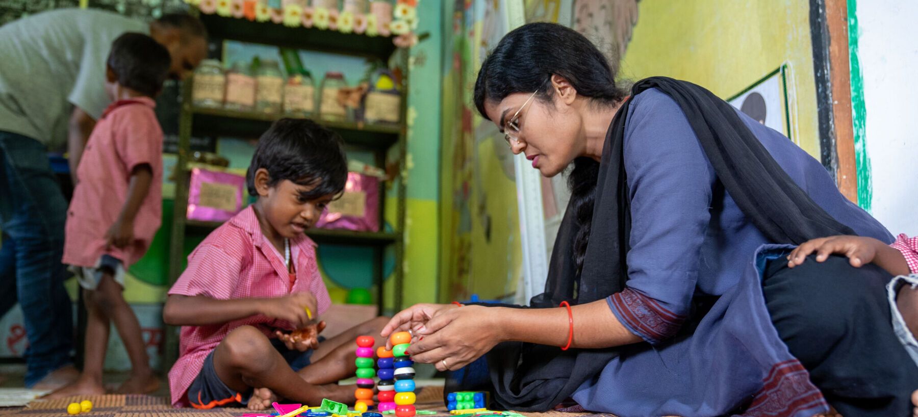ECCE teacher with student