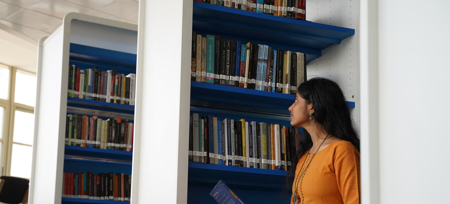 Girl reading book in library